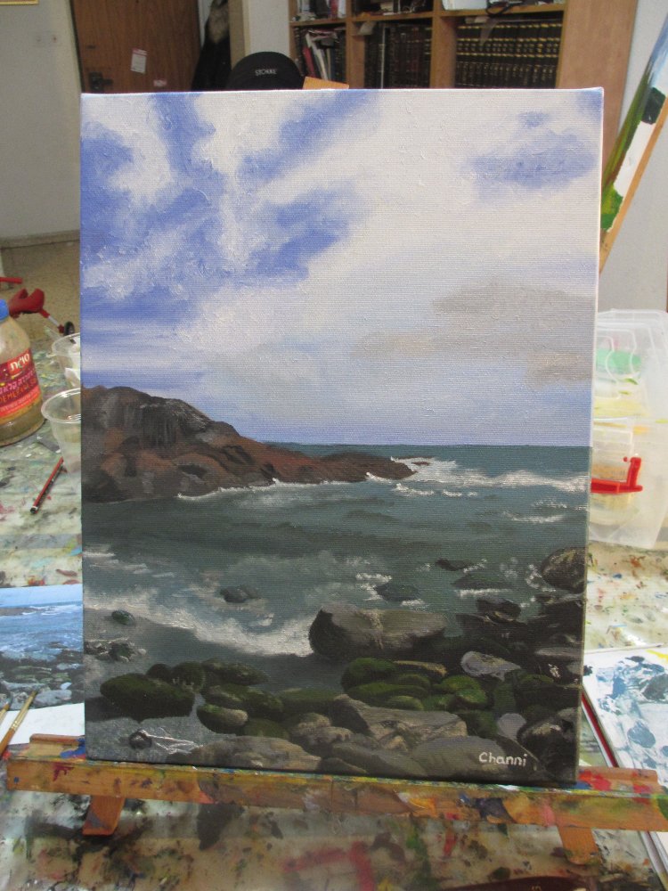 A rocky coastline acrylic painting on an easel