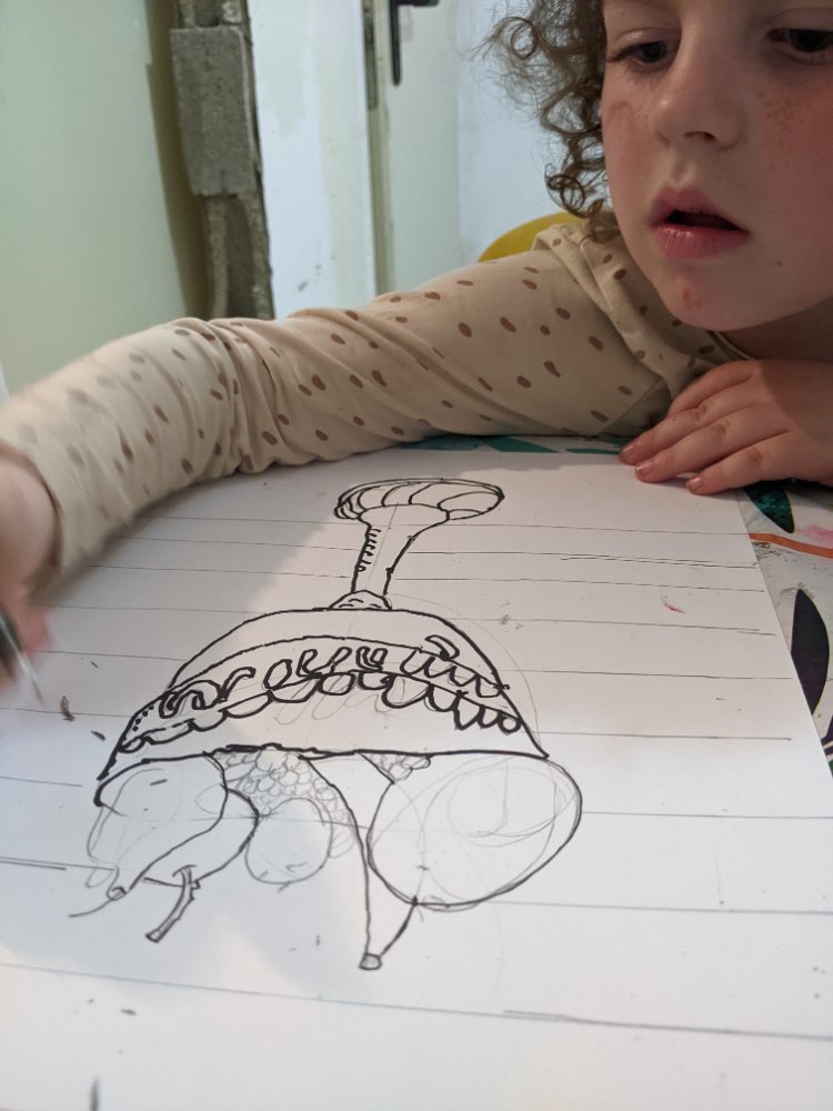 A child working on a detailed ink drawing