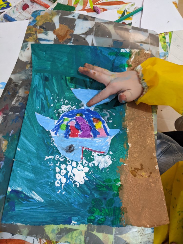 A colourful mixed-media fish collage on a teal sea