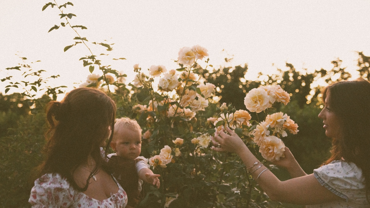 Annie with baby in rose garden