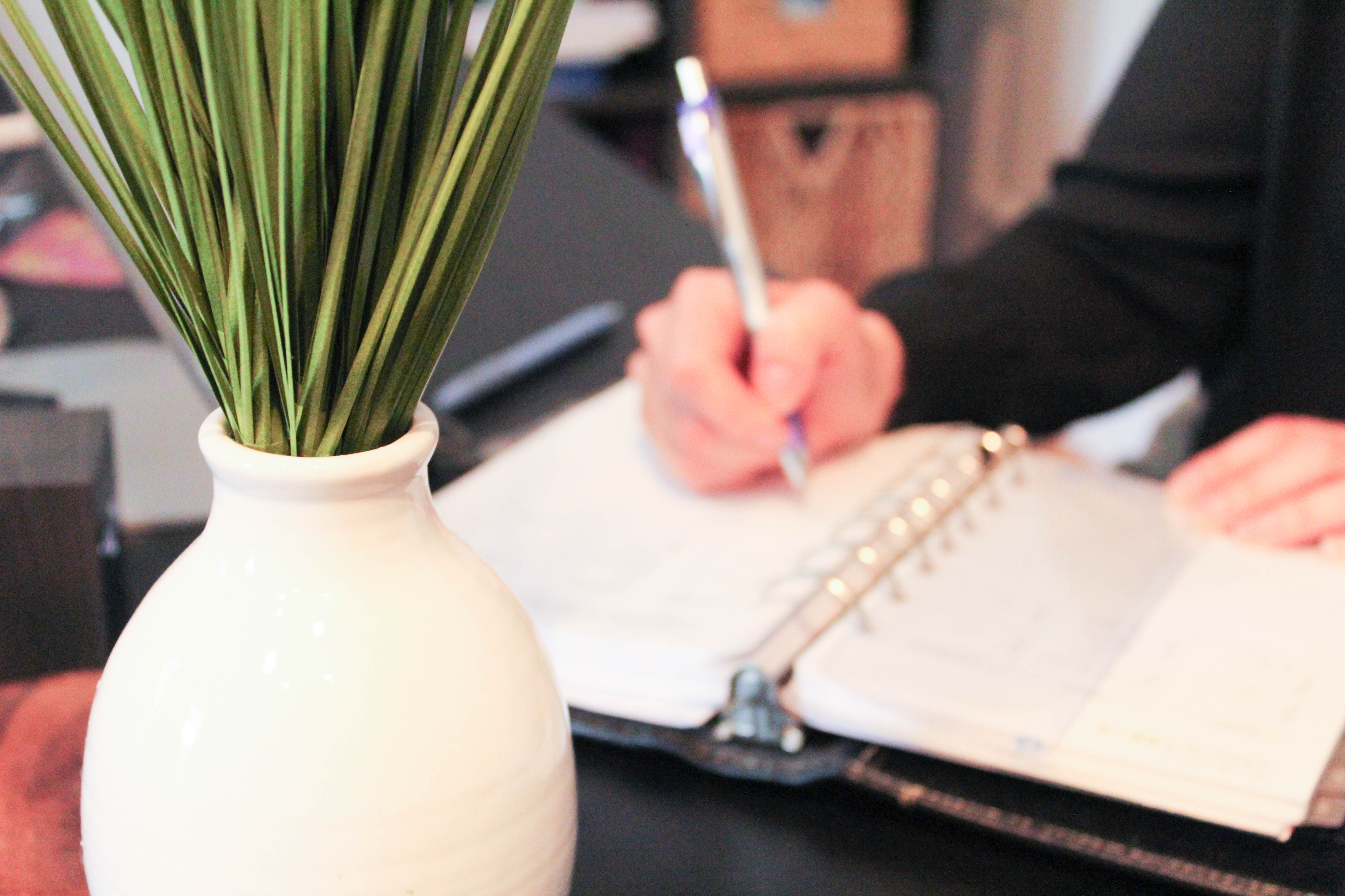 Writing in a planner at a desk