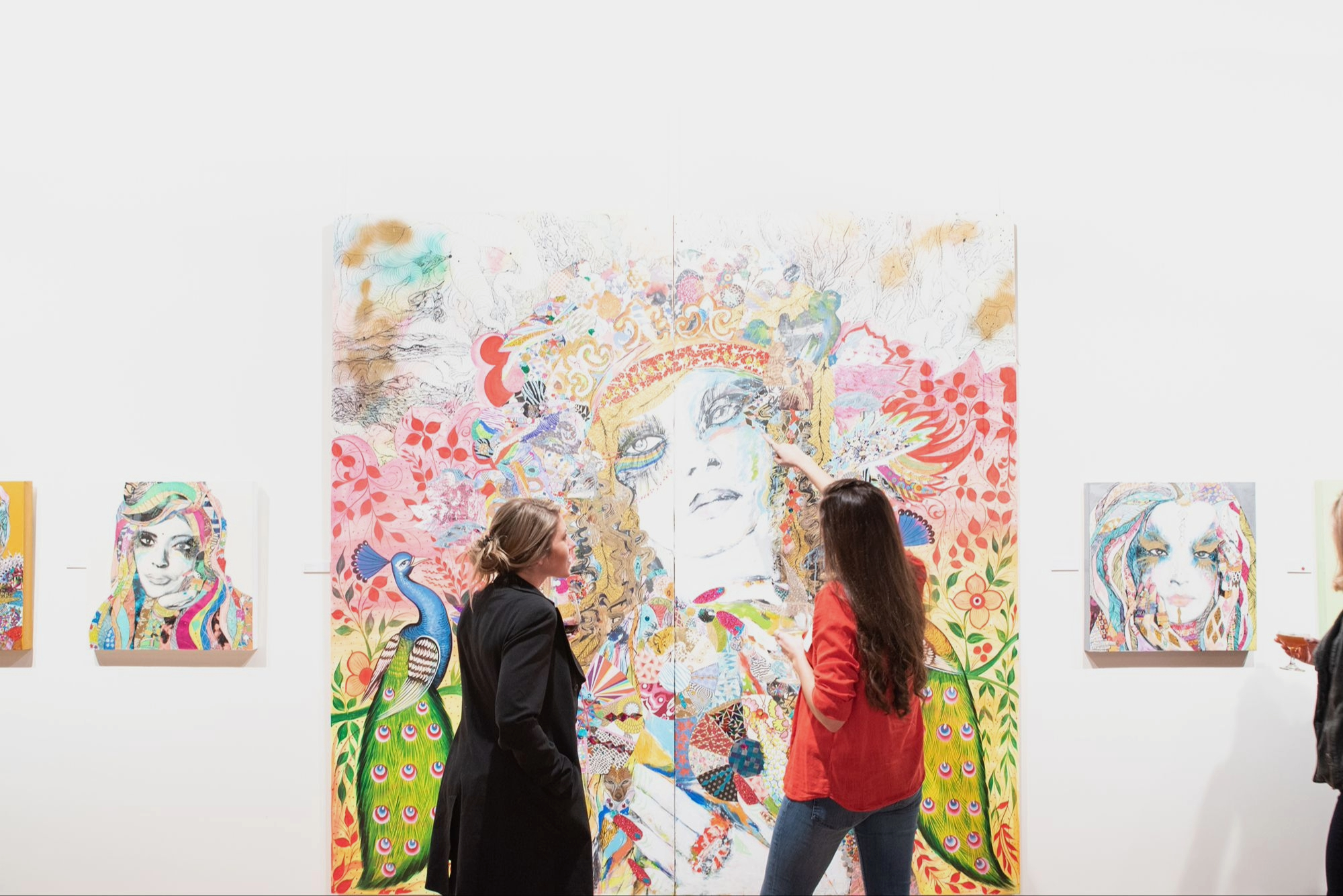 Artist and guest discussing a painting