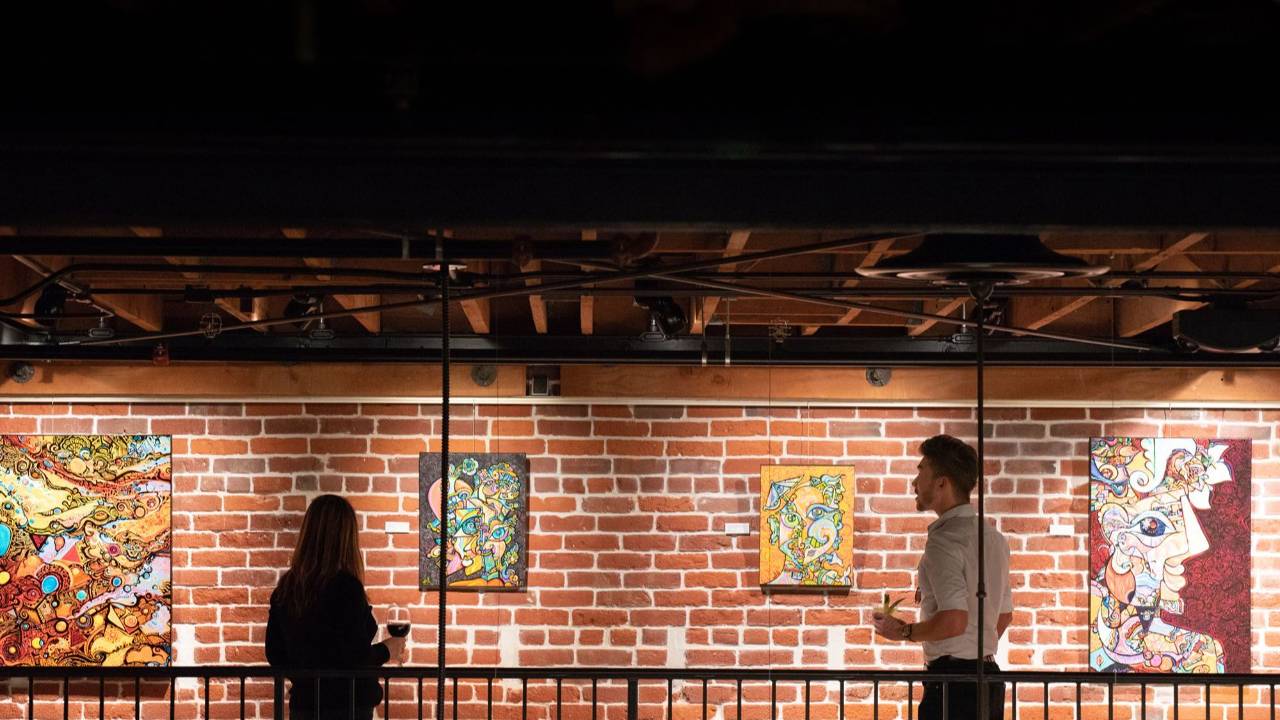 Sparks Gallery interior with colorful contemporary art and brick walls