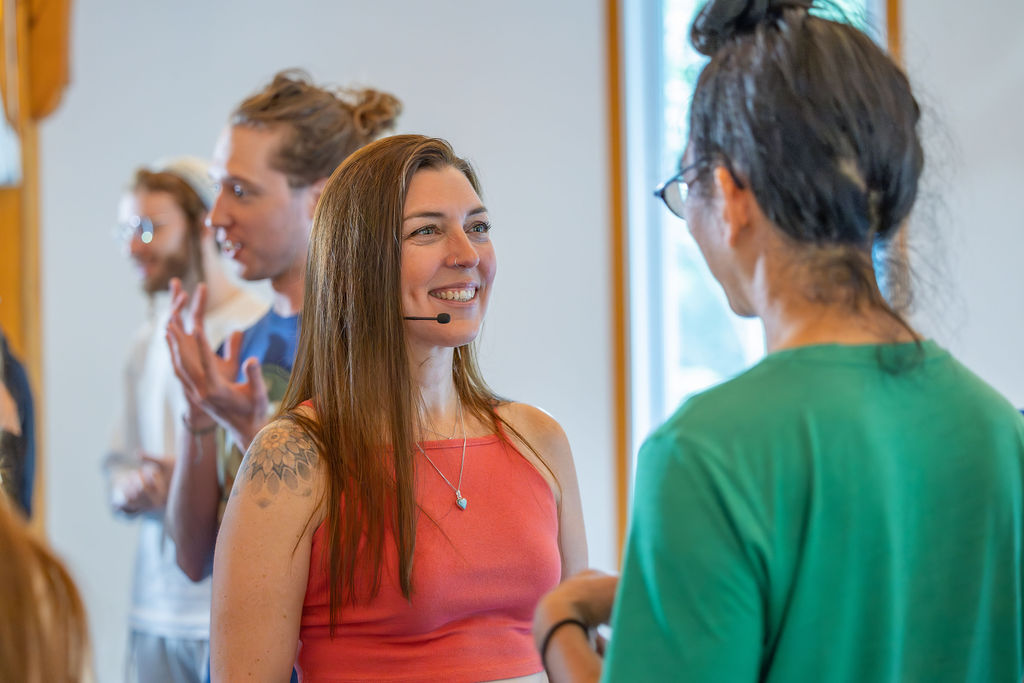 Marilyn smiling as she talks with participants during a workshop