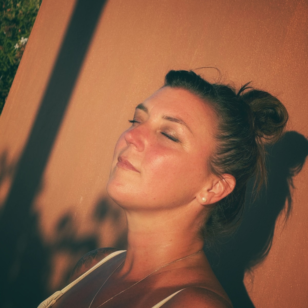 Marilyn with eyes closed, face turned up into warm evening sunlight