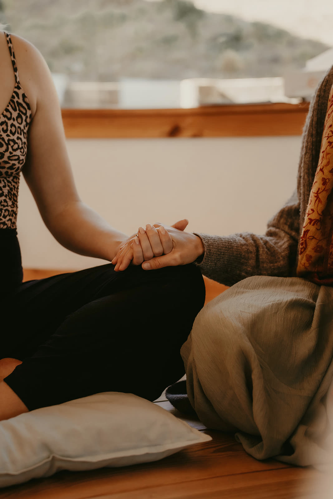 Women holding hands in presence
