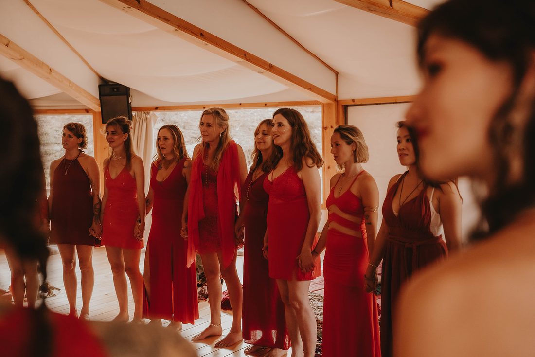 Women in red dresses standing together