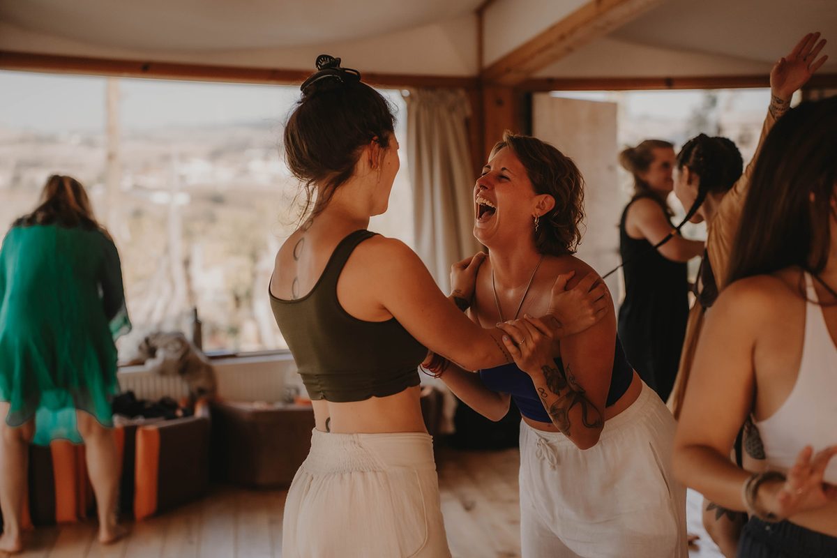 Women laughing together in a circle