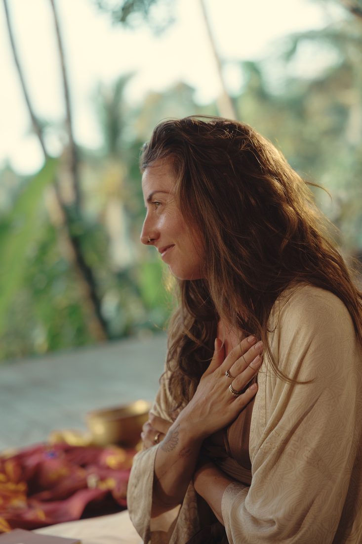 A woman with her hand on her heart