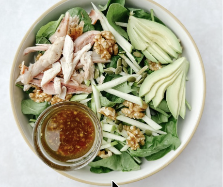 chicken bowl with spinach salad and dressing