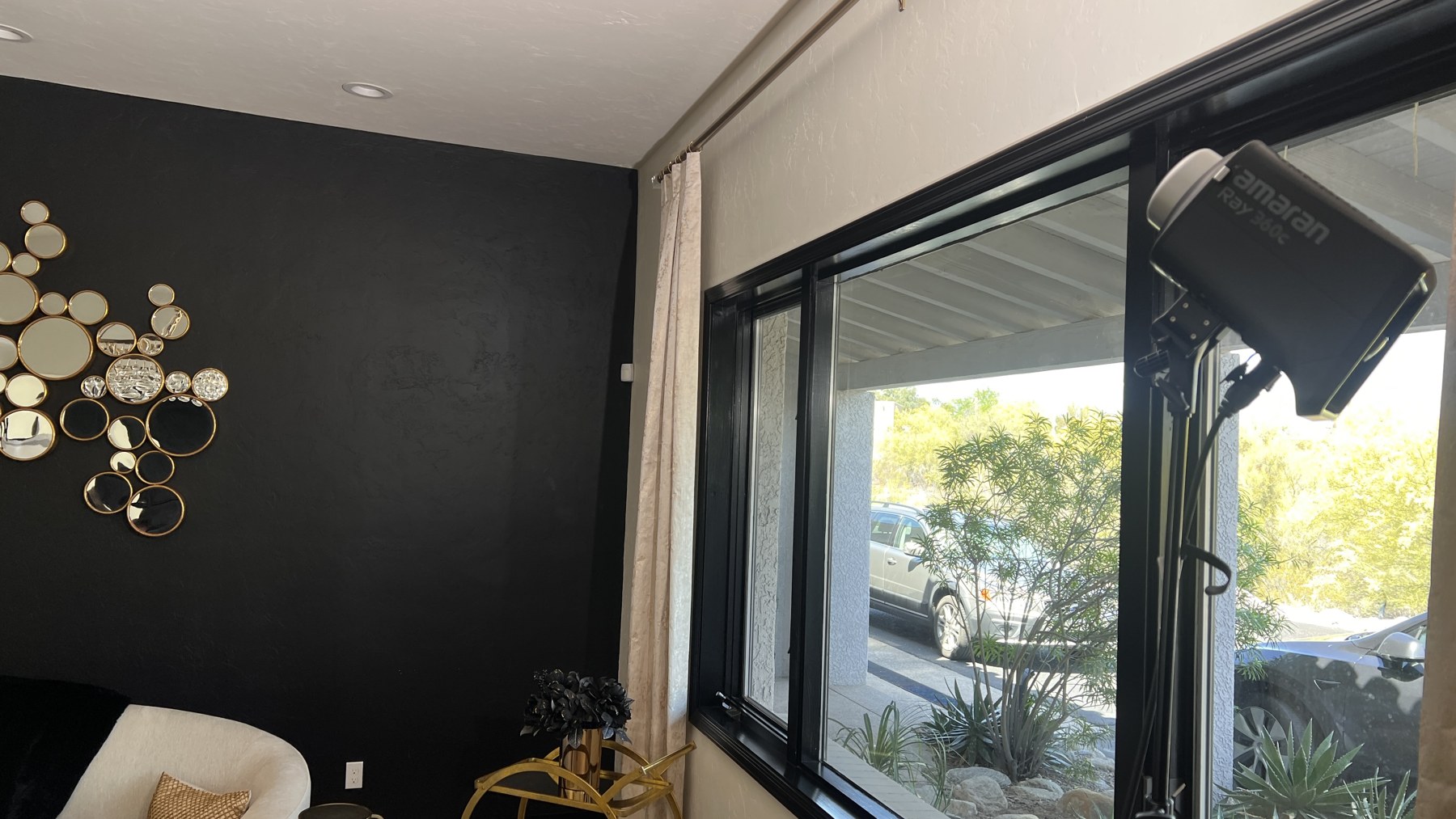 Behind-the-scenes view of the living-room window and amaran 360c used to raise the room level