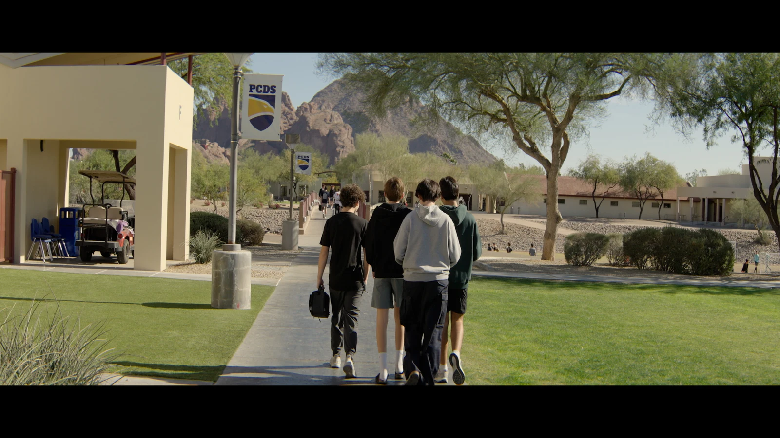 Rec.709 school exterior in Phoenix with students walking toward a mountain