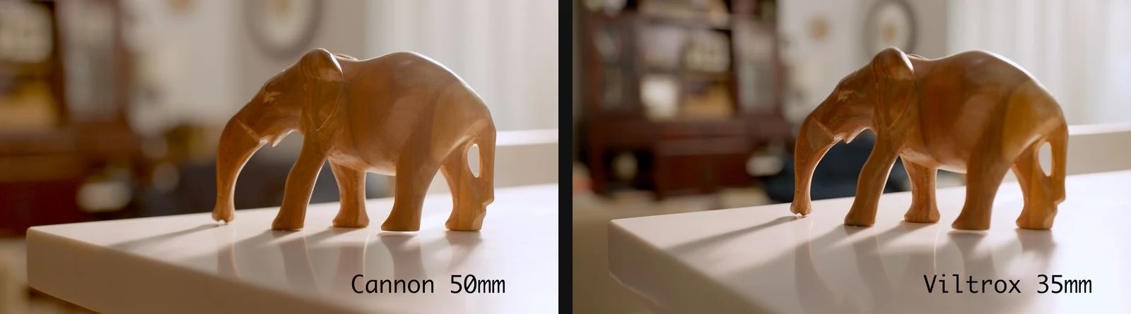 Side-by-side comparison of a wooden elephant filmed with a Canon 50mm and Viltrox 35mm lens