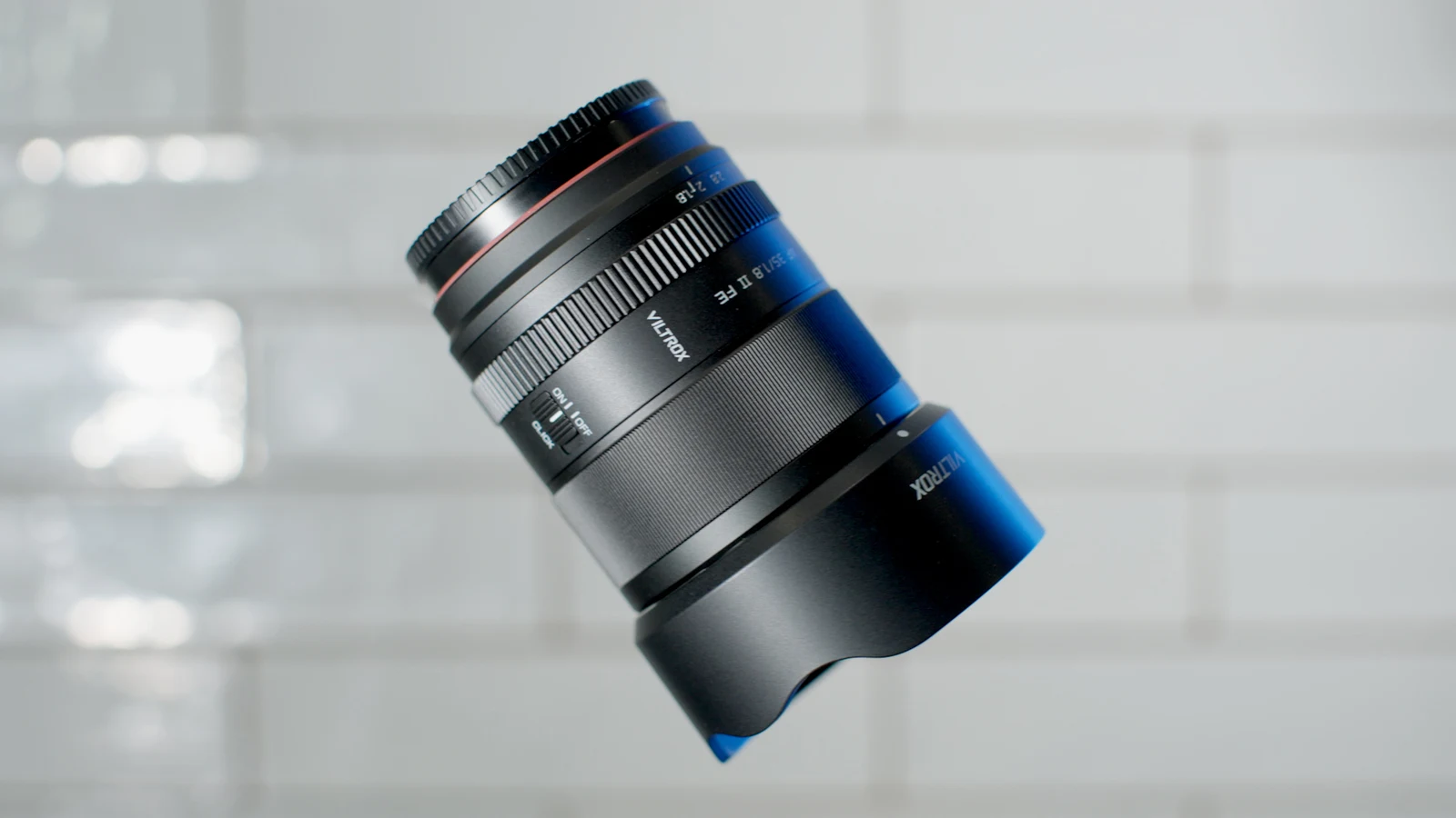 Viltrox 35mm f/1.8 lens photographed against a softly lit background