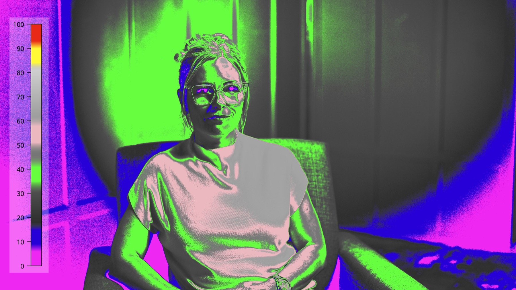 False-color monitor view used to evaluate skin, wardrobe, background, and RGB edge-light exposure in the corporate interview setup