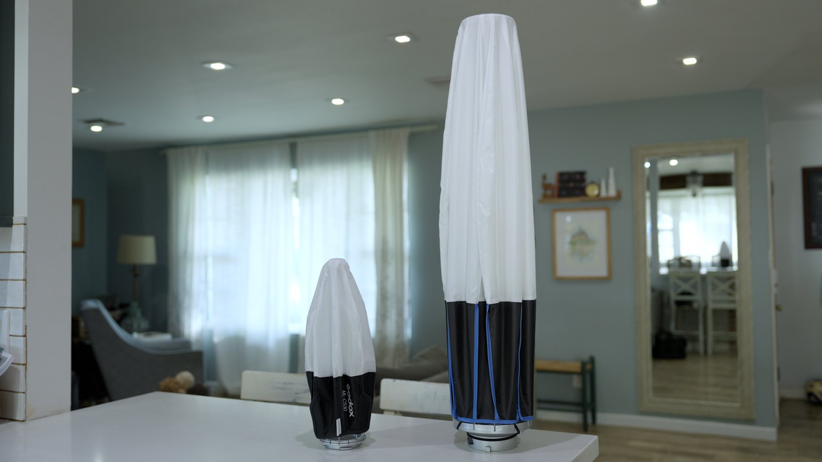 Compact Godox ML-CS30 lantern beside a much taller lantern with both collapsed
