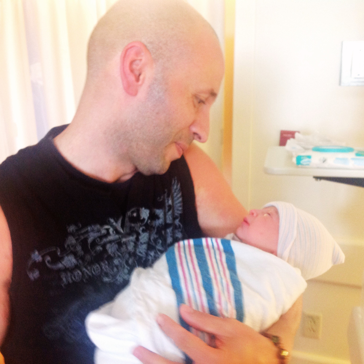 Feras with his newborn baby