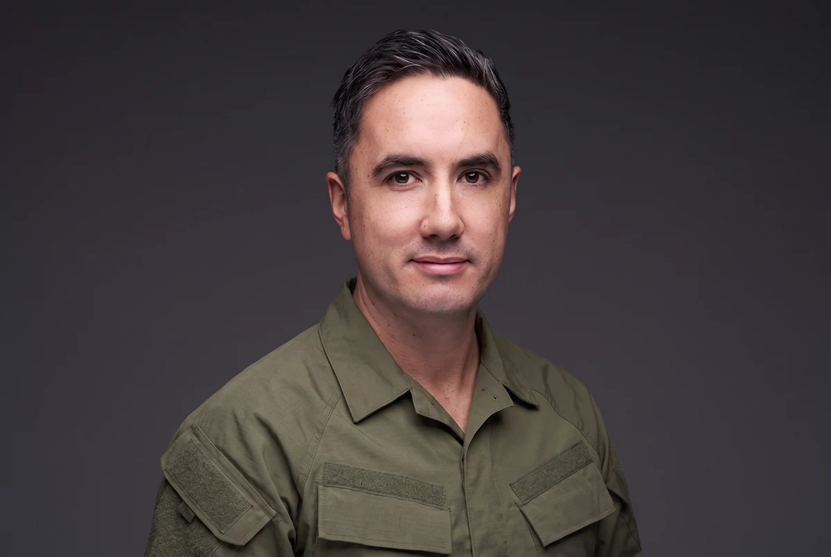 Cole Proebstel in an olive-drab shirt.