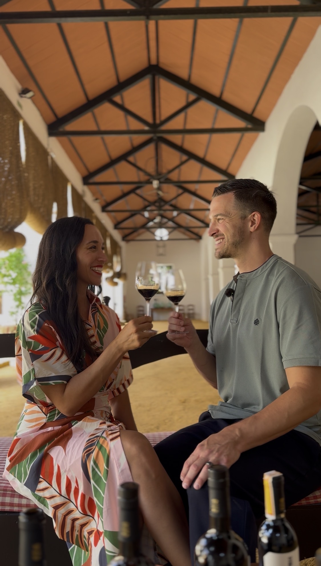 Jess and Eric toasting with a glass of Rioja at a bodega
