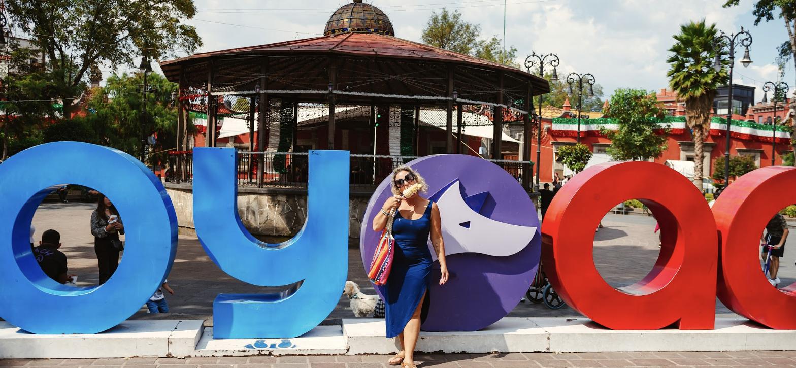 Daniele in front of the colorful Coyoacán letters by the kiosk in the main plaza