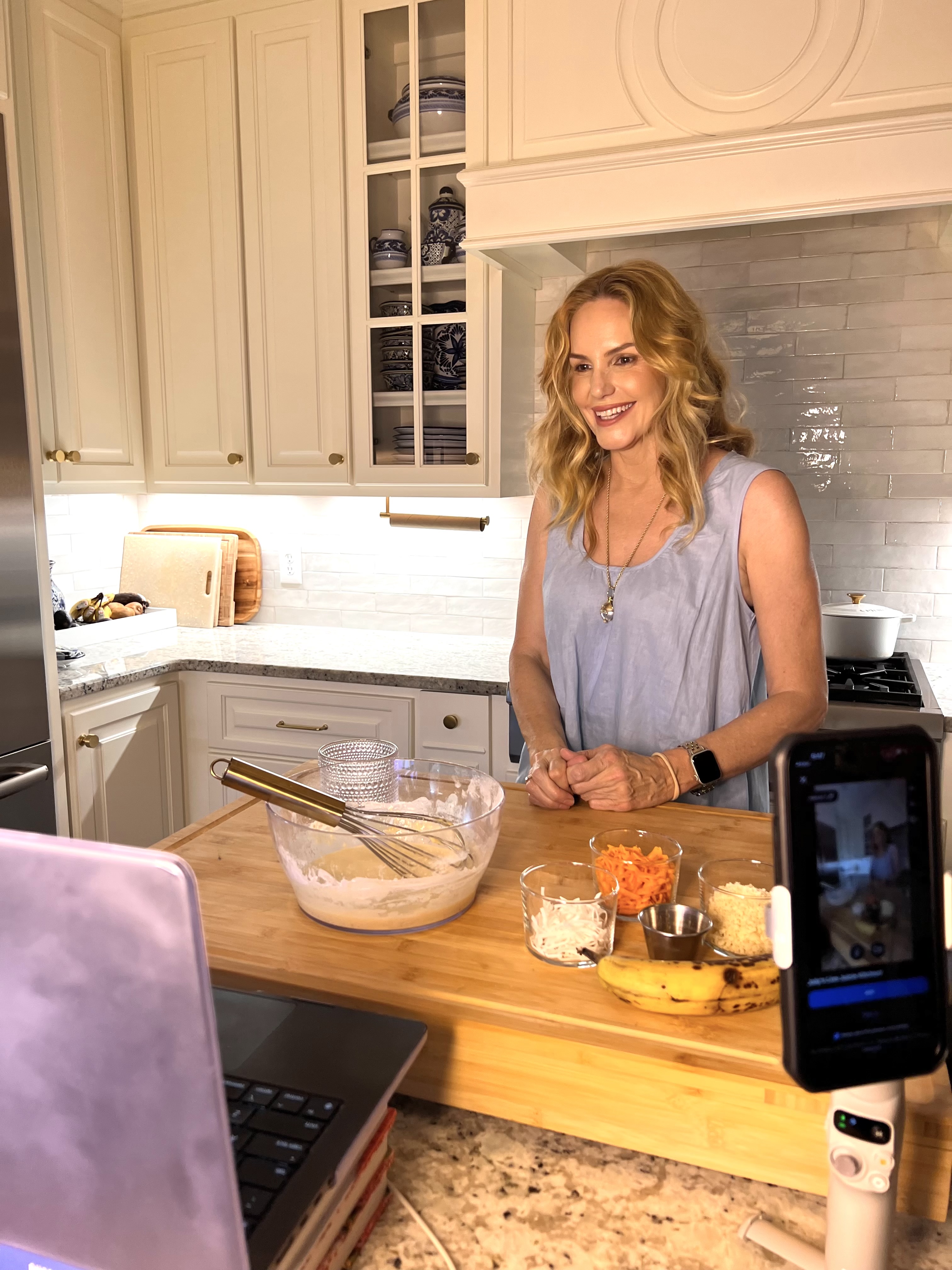 Mee hosting a Live Kitchen with her phone and laptop