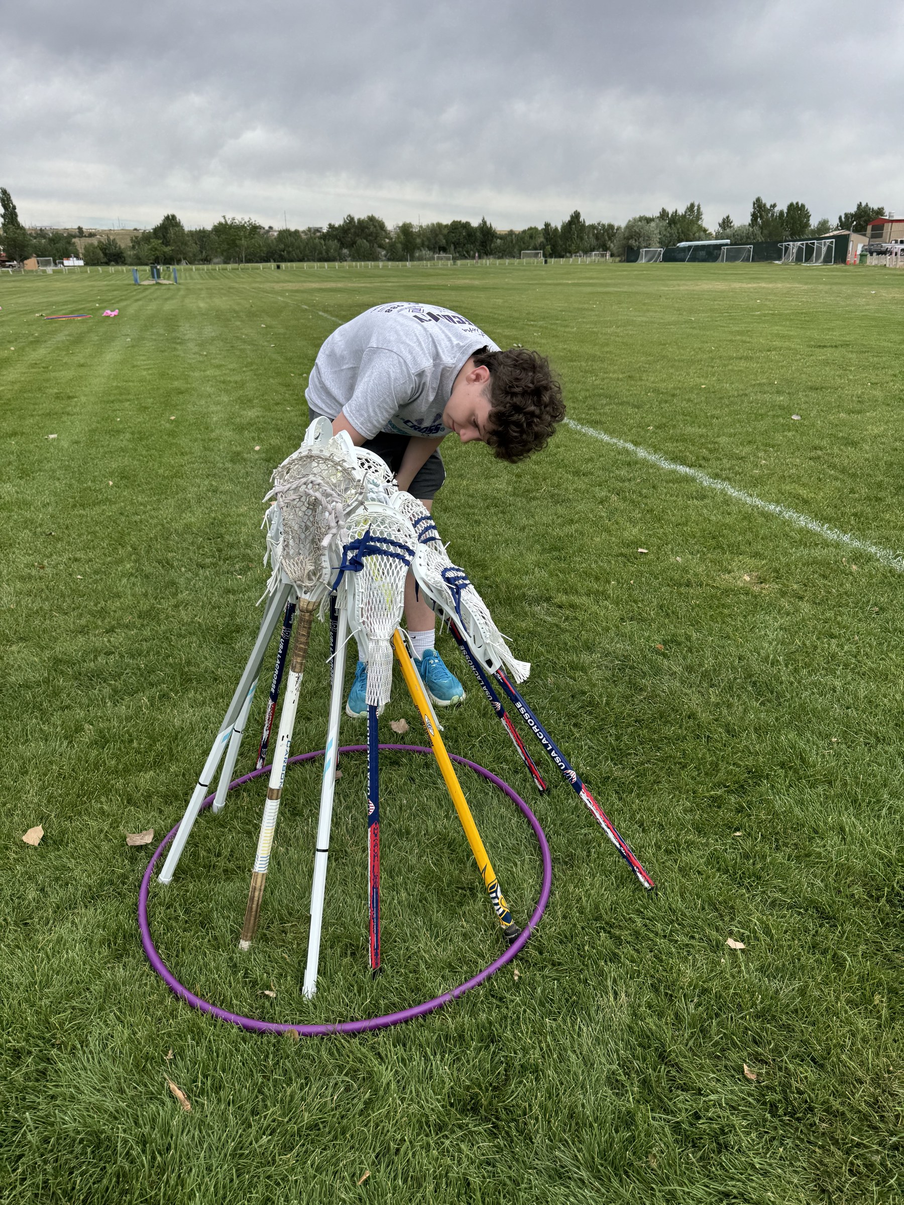 William preparing lacrosse equipment for the community event