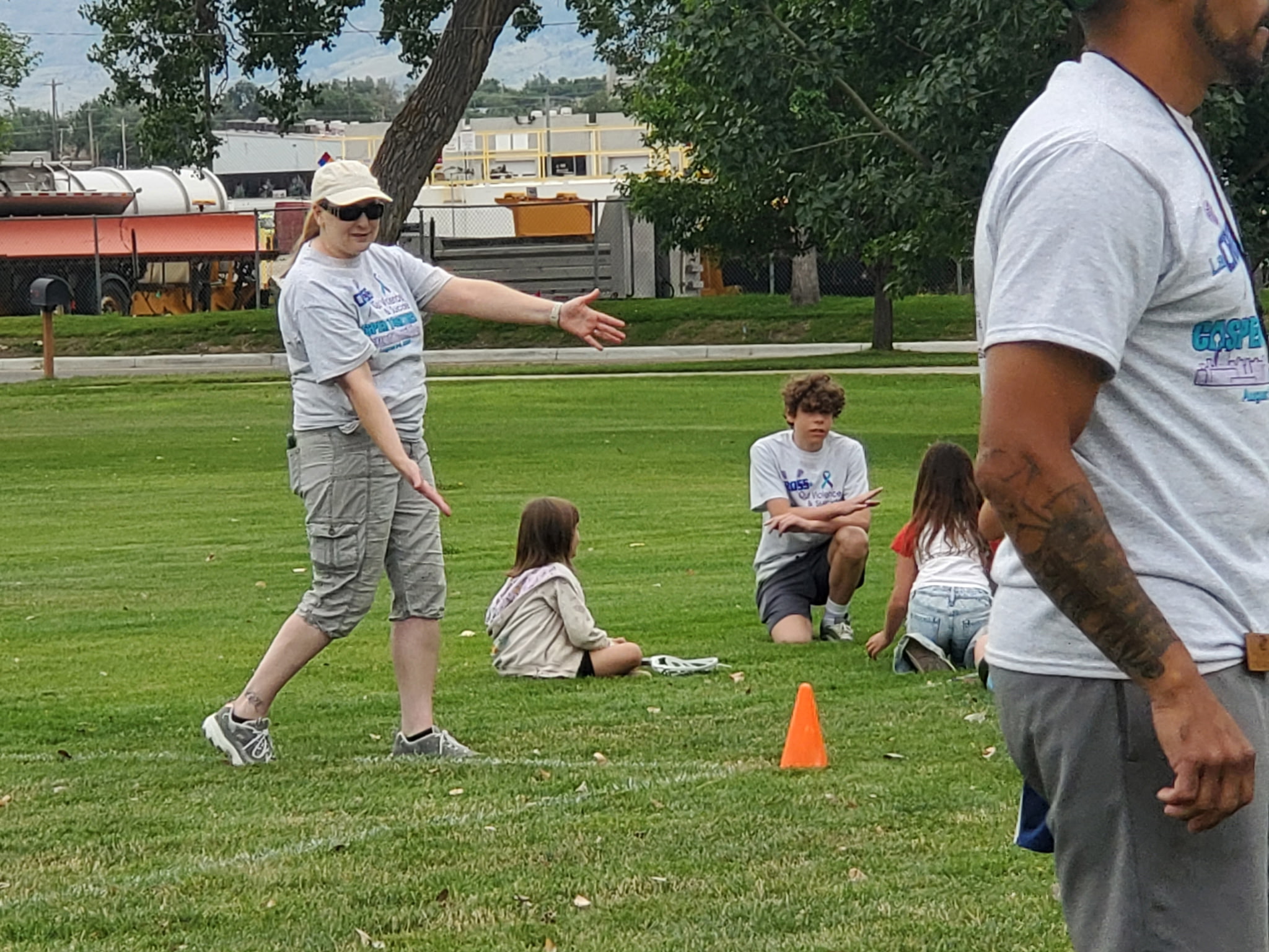 Aidan helping young participants during the lacrosse event