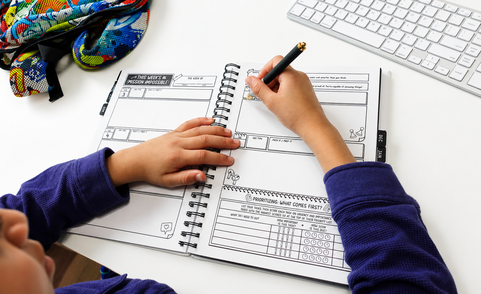 A student writing in The Middle School Master Plan at a desk