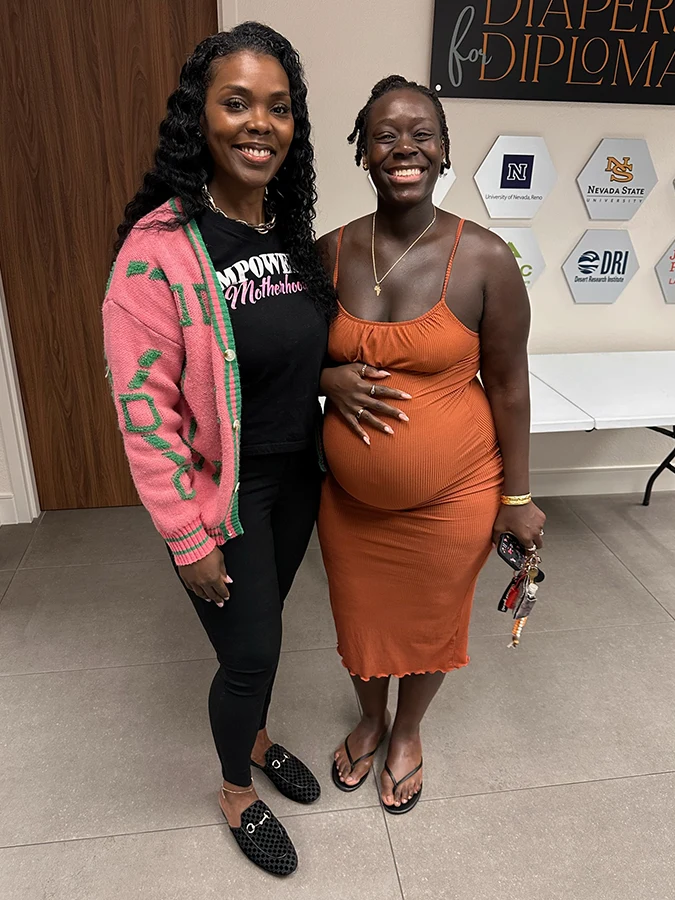 Dr. Eboni January speaking with women at a community health event.
