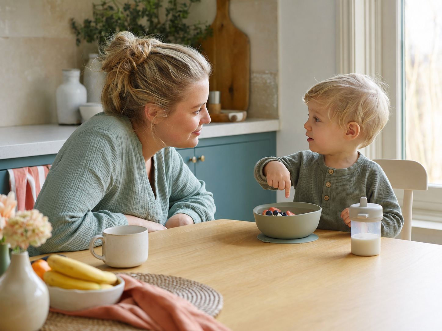 Parent and toddler talking at the breakfast table