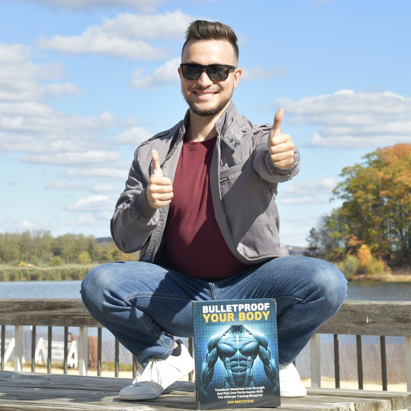 Sam Breitstein holding his book Bulletproof Your Body