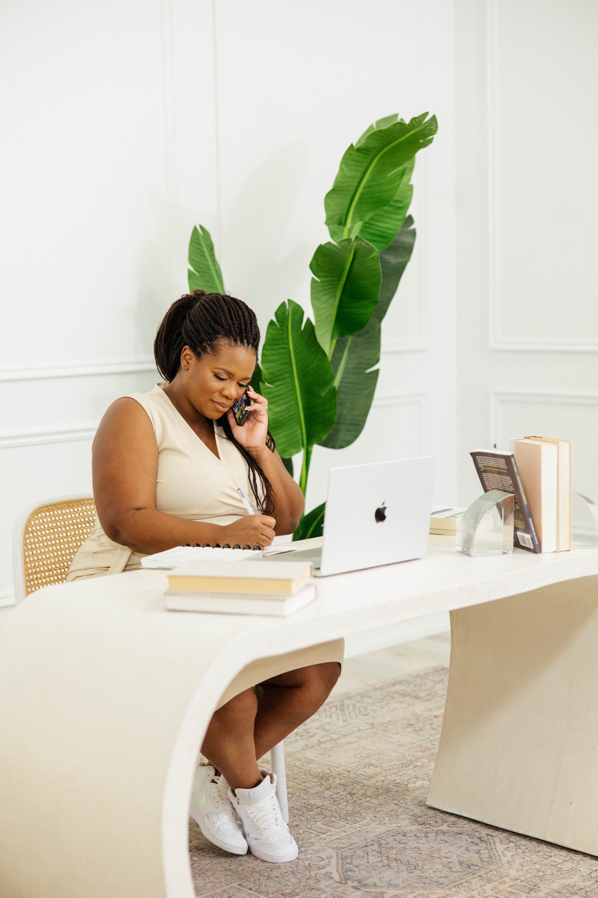 Sophie on a call at her desk, taking notes