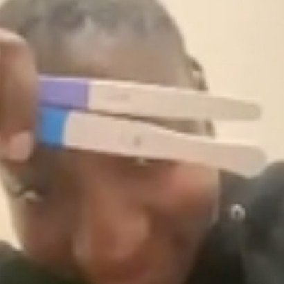 Maria holding up two positive pregnancy tests