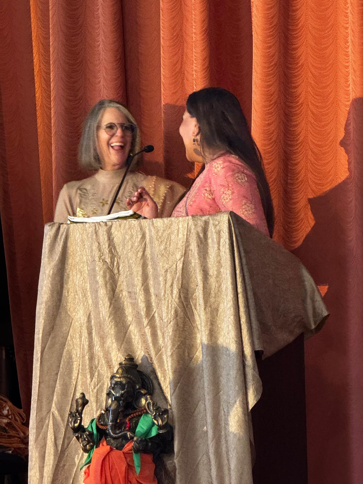Dr. Arlini Singh at the podium during the California College of Ayurveda's 30th Anniversary celebration in Grass Valley, California.
