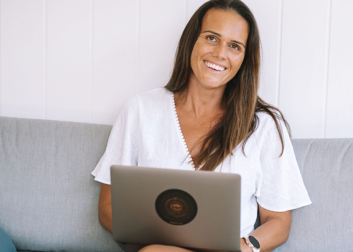 Hayley Ryan working at her laptop, occupational therapist and founder of Fun Mums