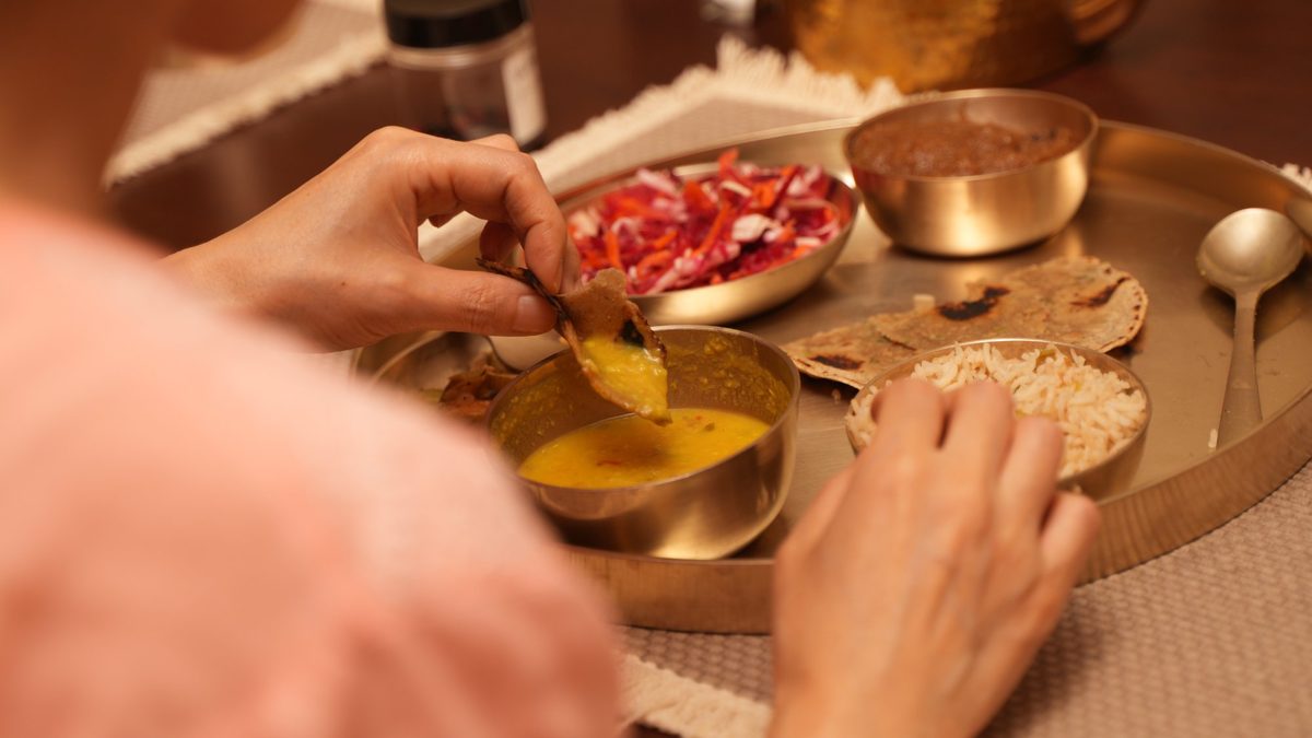 A Sattvic meal on a brass thali at Sattva Campus