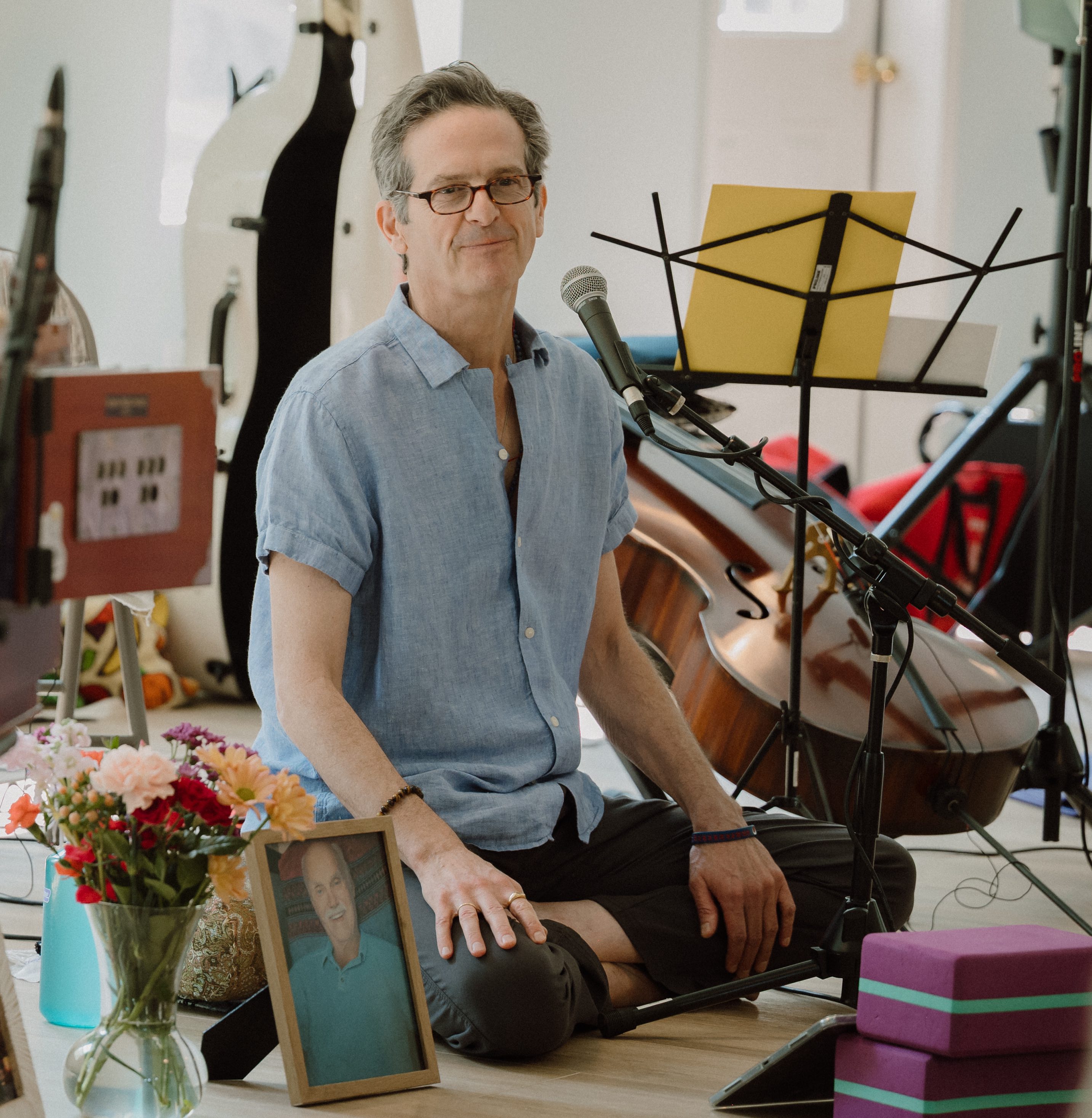 Noah Hoffeld seated with his cello, leading a meditation class