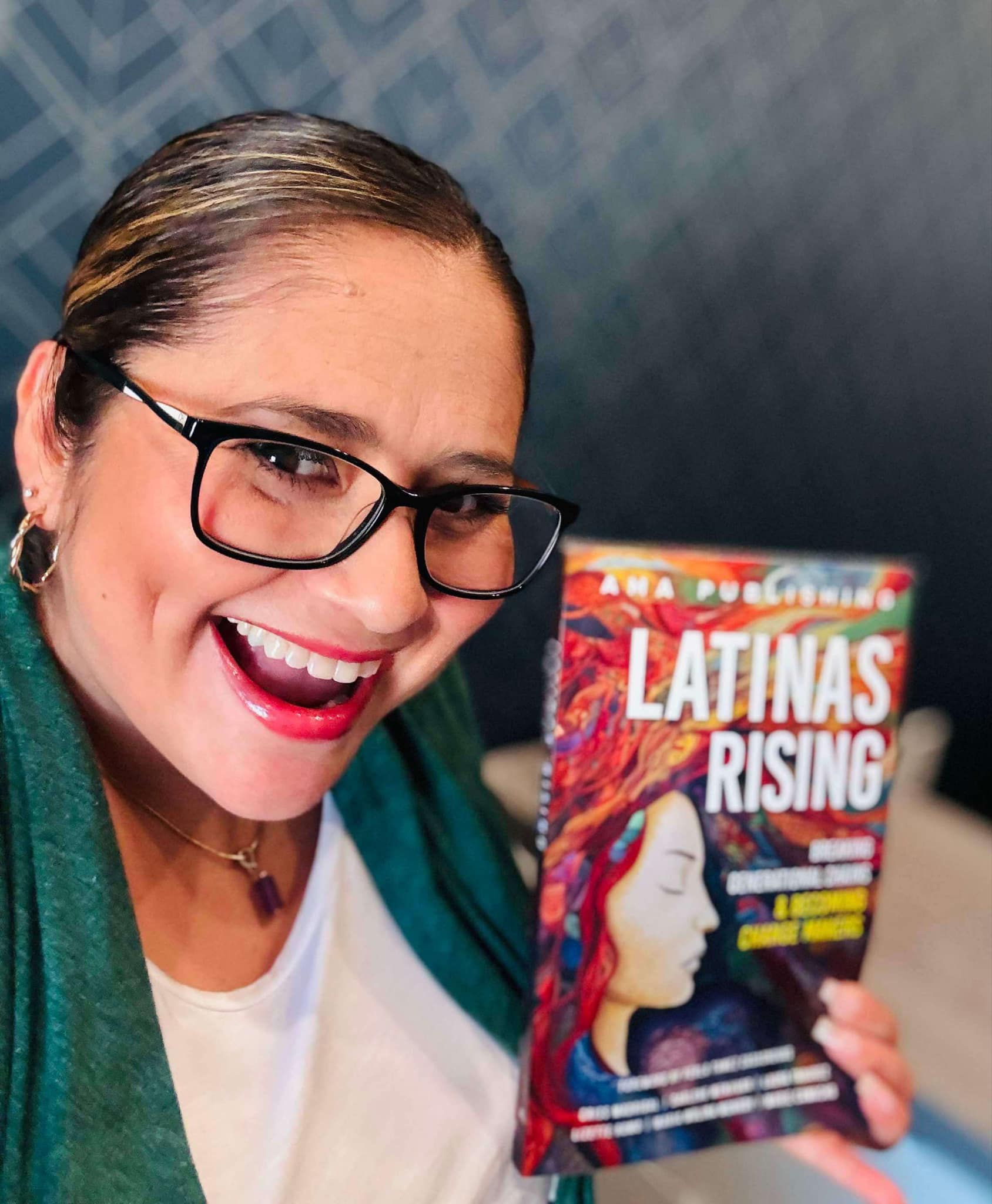 Laura Tabarez holding Latinas Rising