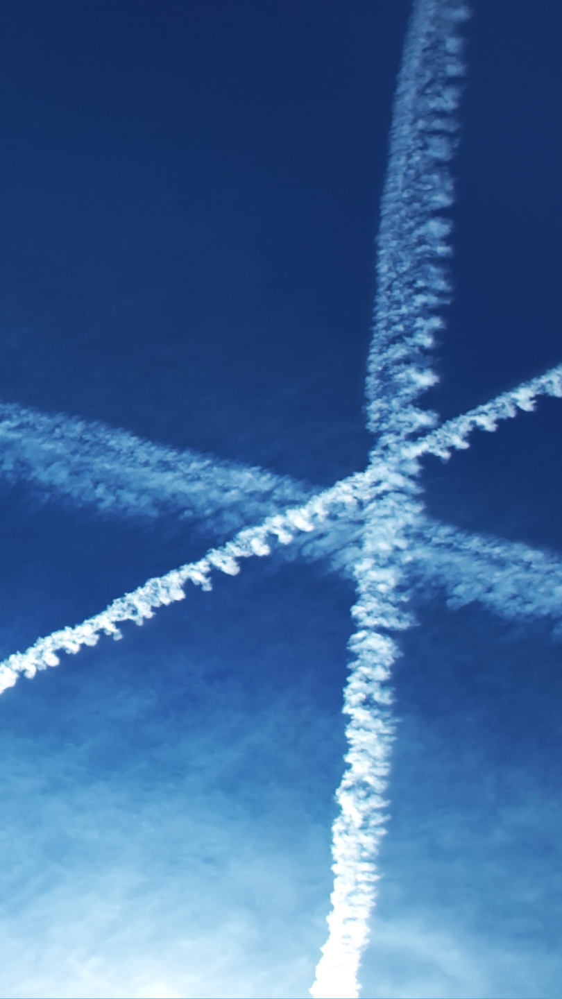 Geoengineering trails spread across the sky