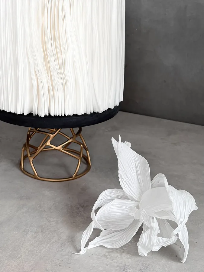 Wafer paper tier on a gold stand with a crepe paper flower