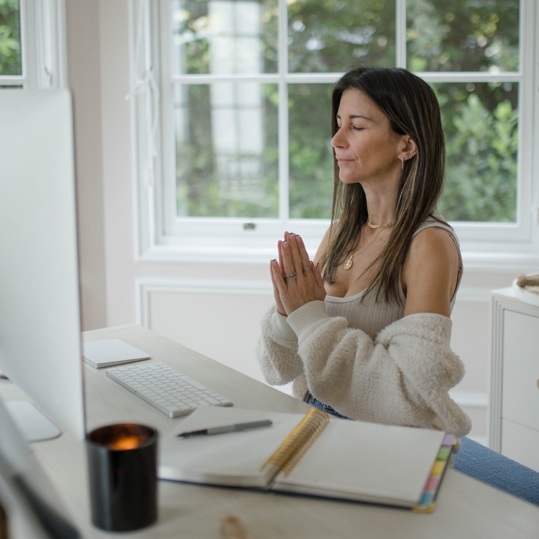 Alexis meditating at her desk