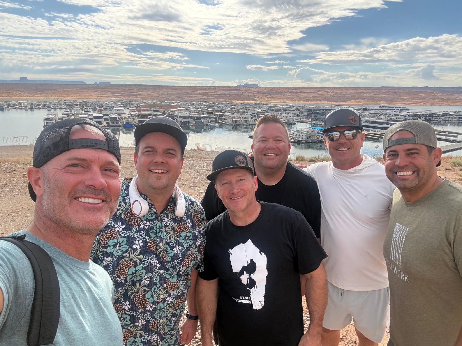 Six Man Camp participants posing at the marina