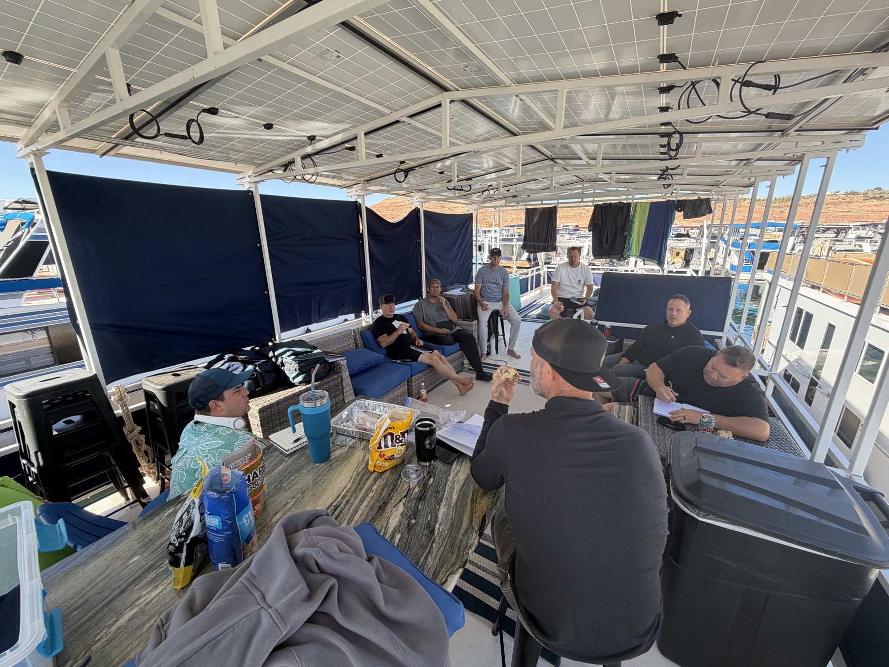 Men gathered on the houseboat for a guided development session