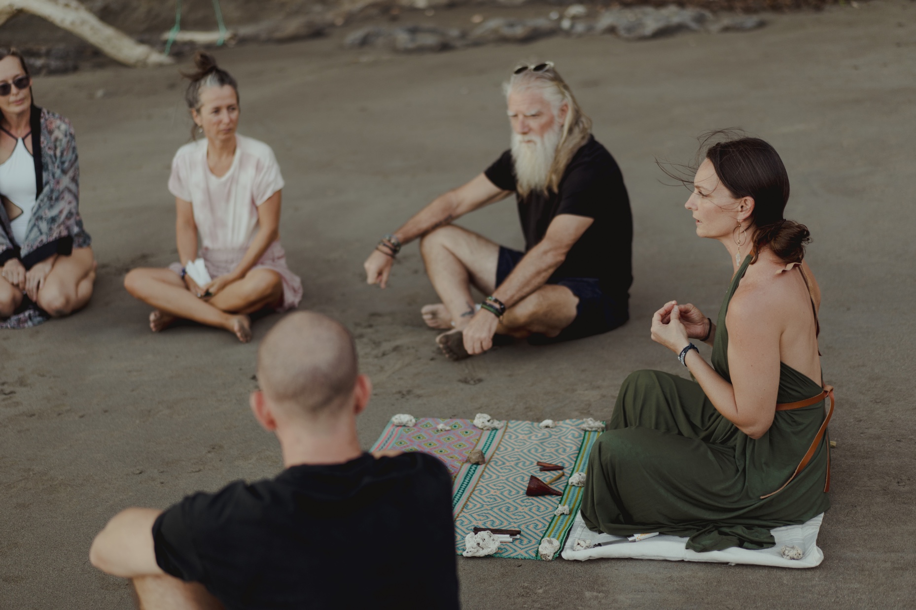 Brandi guiding a circle on the beach in Costa Rica