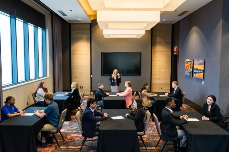 A NEGOTIATi session around a conference table, with participants engaged in discussion