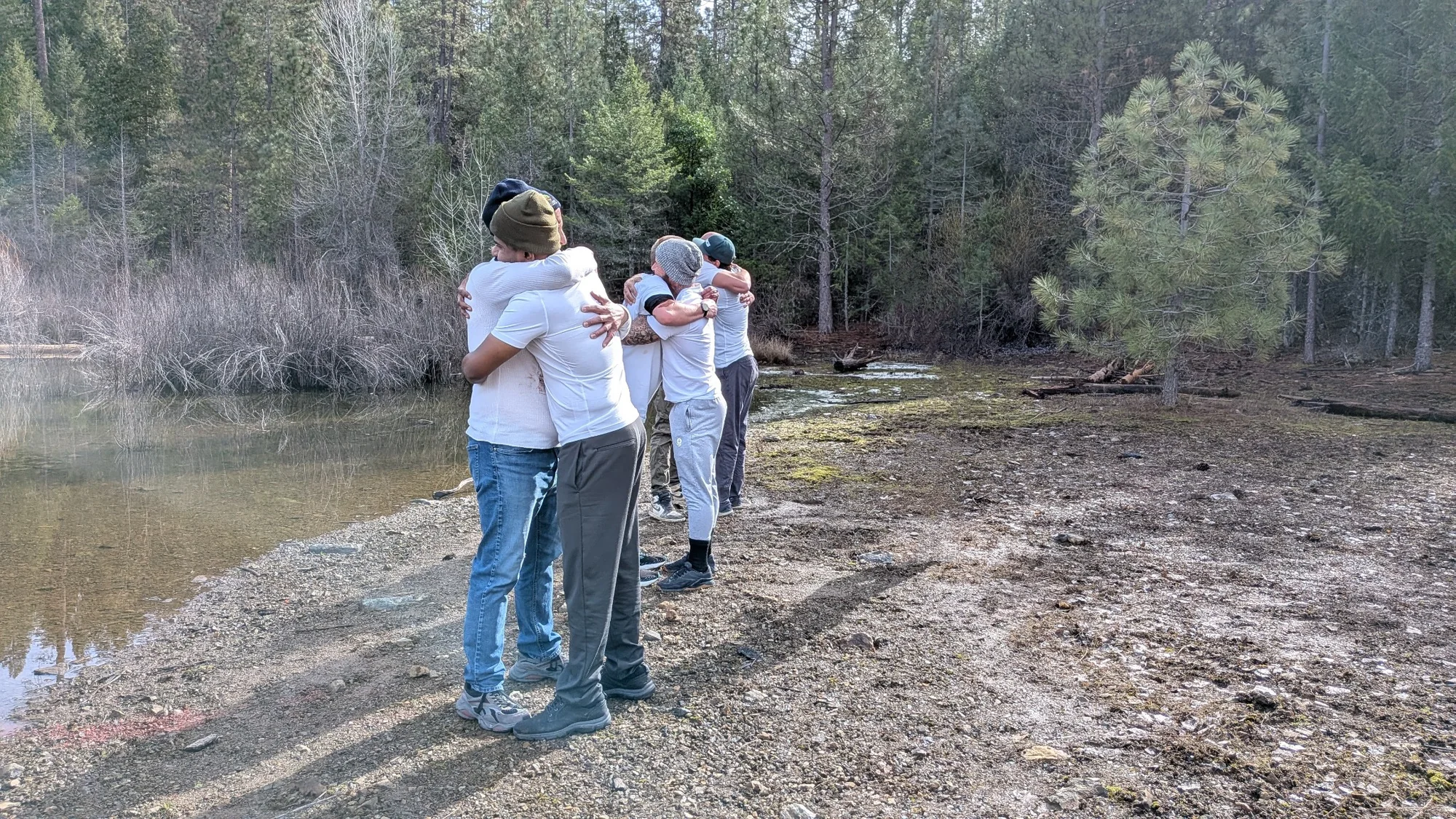 Men embracing at the Return to the Body retreat