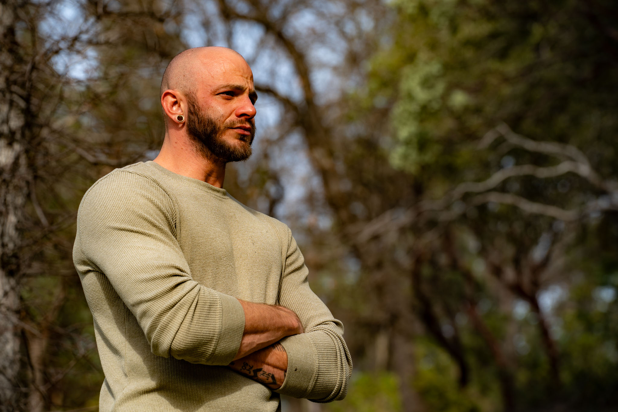 A man pausing in grounded reflection in the forest