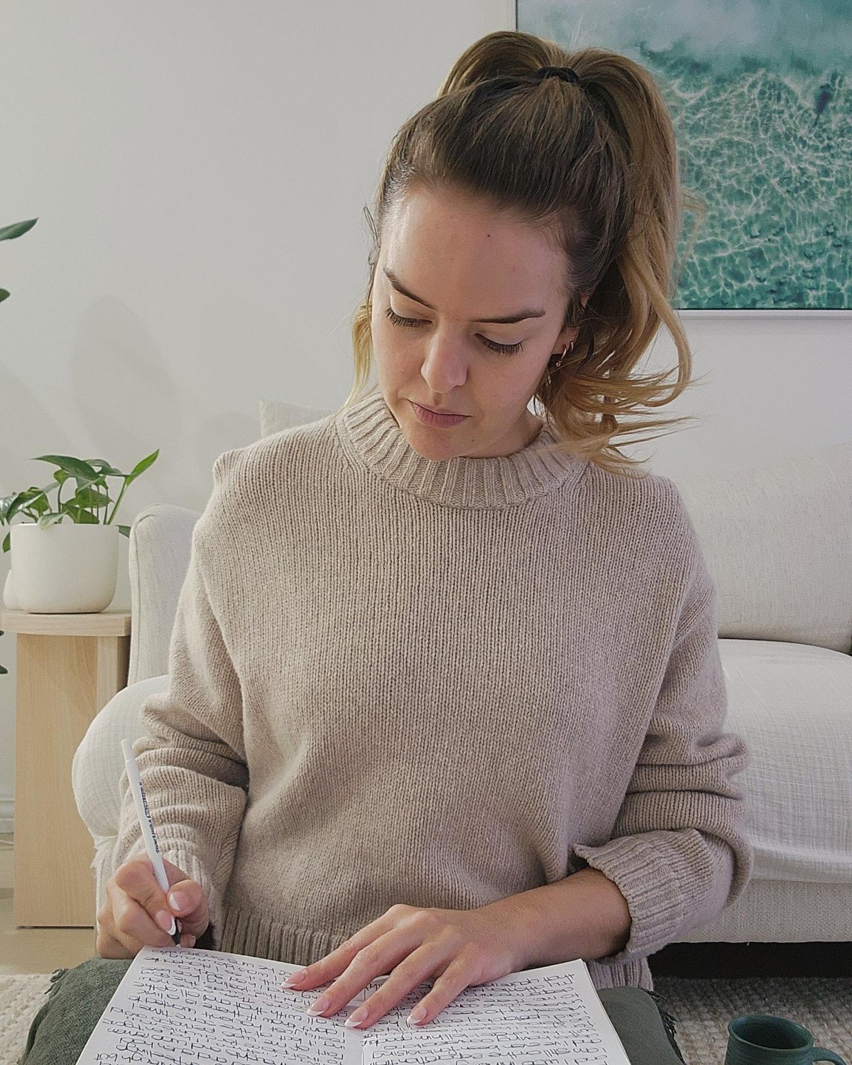 Amanda writing in her journal at home