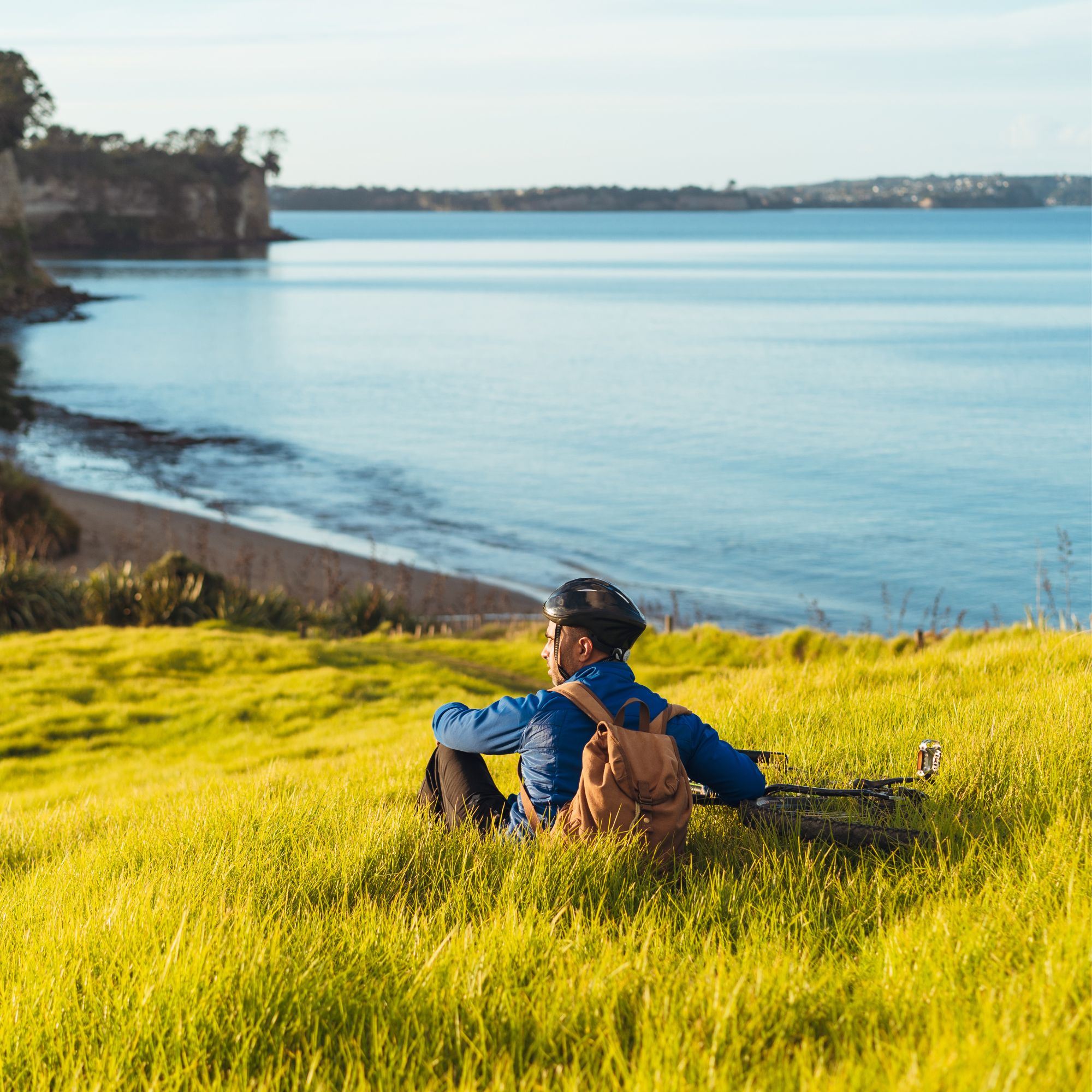 Person sitting by the coast