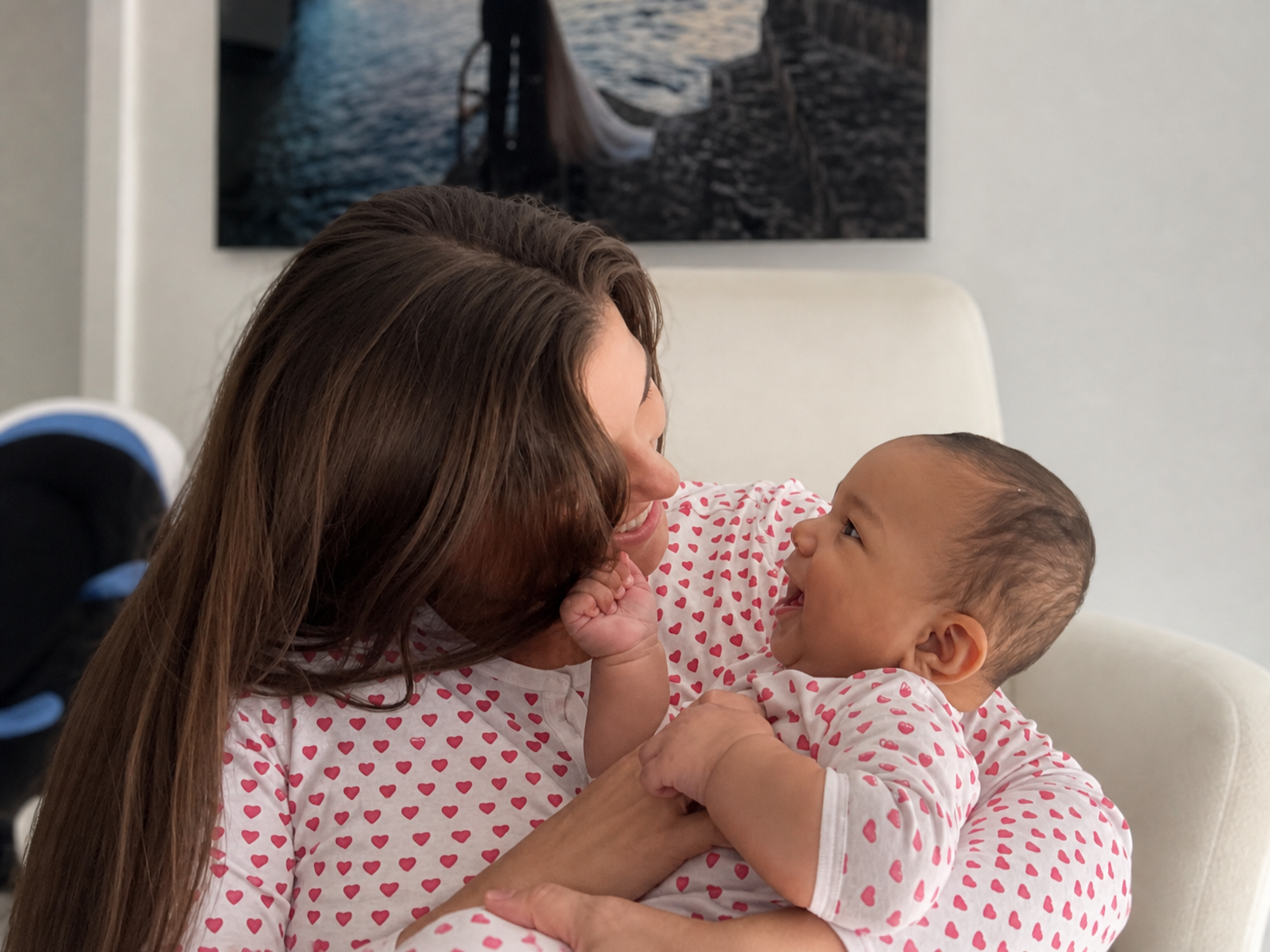 Mother smiling at her newborn during a close, affectionate moment